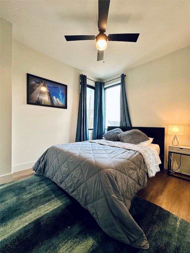 210 E 39th St, Houston, TX 77018 - bedroom featuring wood finished floors, baseboards, and a ceiling fan