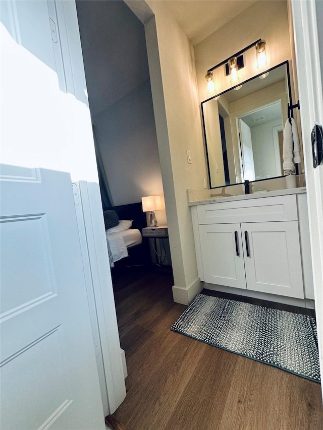 210 E 39th St, Houston, TX 77018 - bathroom featuring wood finished floors, vanity, and baseboards