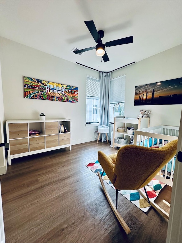 210 E 39th St, Houston, TX 77018 - living area featuring a ceiling fan, wood finished floors, and baseboards