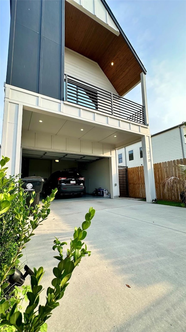 210 E 39th St, Houston, TX 77018 - view of home's exterior featuring a balcony, driveway, and a garage