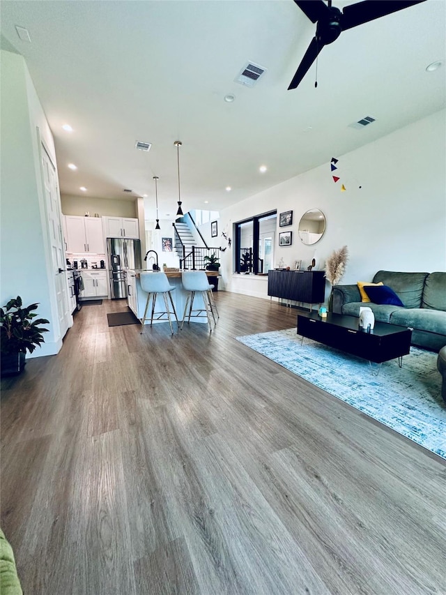 210 E 39th St, Houston, TX 77018 - living room featuring a ceiling fan, dark wood finished floors, and recessed lighting