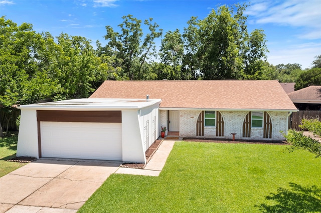 16915 Stardale Ln, Friendswood, TX 77546 - view of front facade featuring a front lawn, roof with shingles, driveway, and brick siding