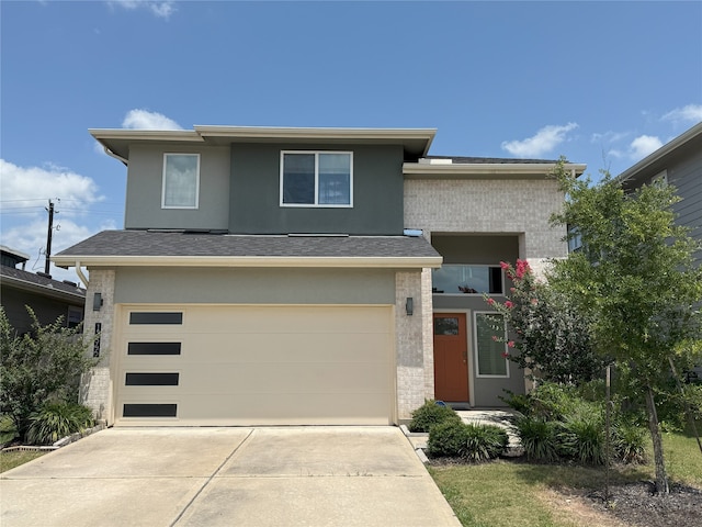 12545 Walmgate Ct, Houston, TX 77047 - prairie-style home with concrete driveway, an attached garage, stucco siding, and a shingled roof