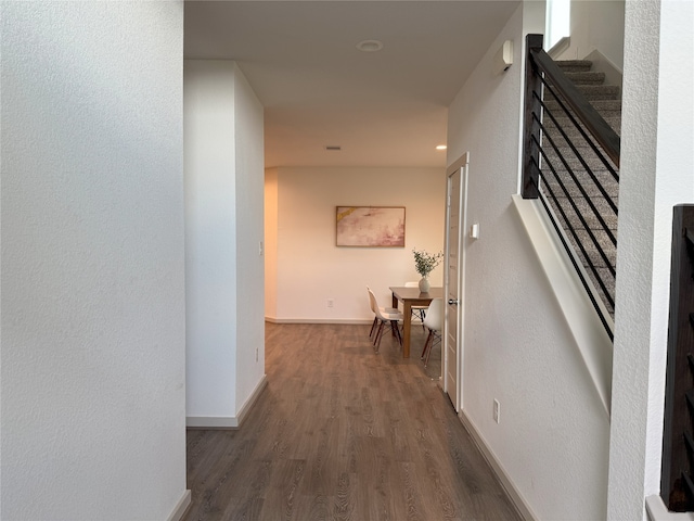 12545 Walmgate Ct, Houston, TX 77047 - hall with wood finished floors, baseboards, and stairway