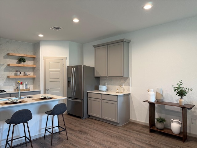 12545 Walmgate Ct, Houston, TX 77047 - kitchen featuring gray cabinets, stainless steel fridge, backsplash, and recessed lighting