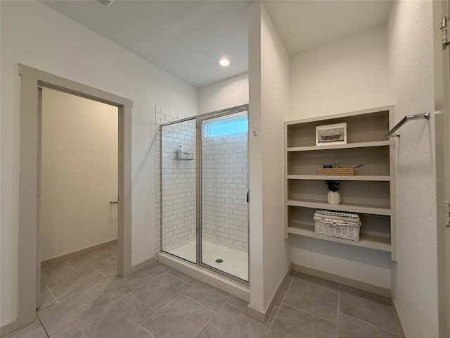 12545 Walmgate Ct, Houston, TX 77047 - bathroom featuring a stall shower, baseboards, and tile patterned flooring