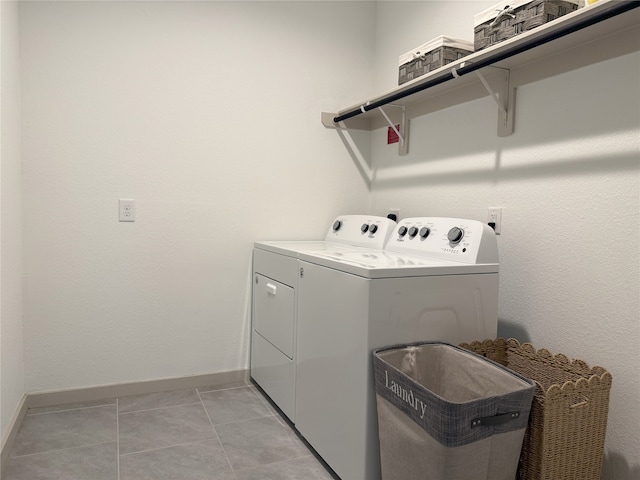 12545 Walmgate Ct, Houston, TX 77047 - washroom with separate washer and dryer, baseboards, and light tile patterned floors