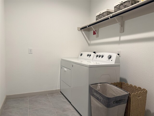 12545 Walmgate Ct, Houston, TX 77047 - washroom with independent washer and dryer, baseboards, and light tile patterned floors