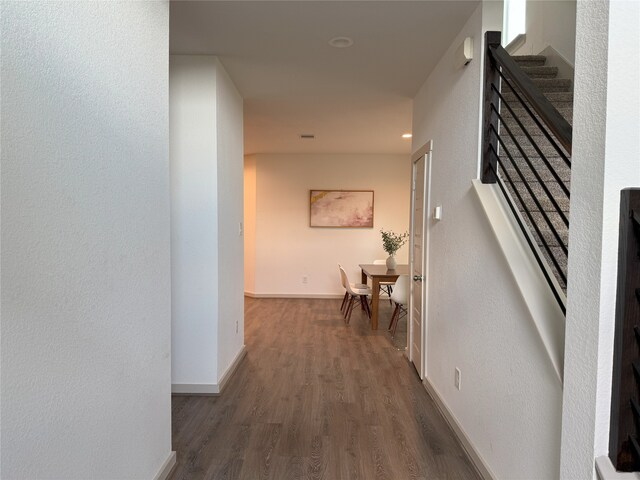 12545 Walmgate Ct, Houston, TX 77047 - hallway featuring wood finished floors, baseboards, and stairway