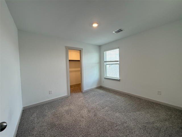 12545 Walmgate Ct, Houston, TX 77047 - unfurnished bedroom with light colored carpet, a spacious closet, and baseboards