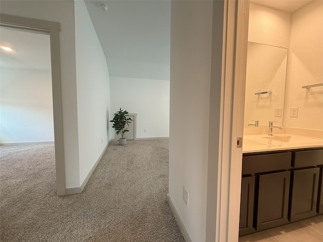 12545 Walmgate Ct, Houston, TX 77047 - corridor with light colored carpet, a sink, and baseboards