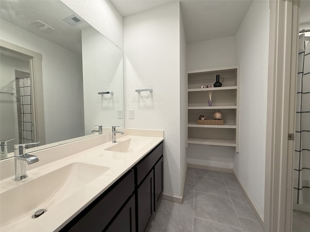 12545 Walmgate Ct, Houston, TX 77047 - full bathroom featuring double vanity, tile patterned flooring, and baseboards