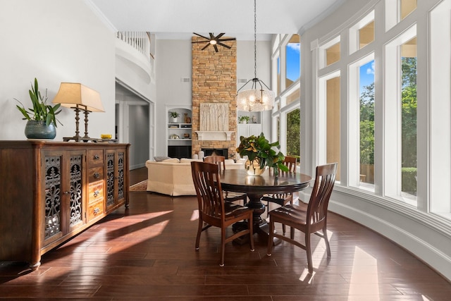 91 N Hunters Crossing Cir, The Woodlands, TX 77381 - dining room featuring a chandelier, a high ceiling, dark wood finished floors, built in shelves, and baseboards