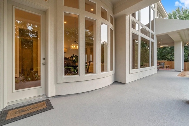 91 N Hunters Crossing Cir, The Woodlands, TX 77381 - view of exterior entry with a patio area and stucco siding