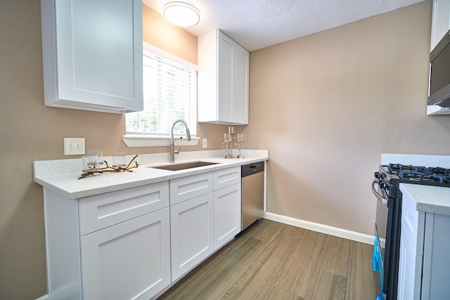 11706 Mclain Blvd, Houston, TX 77071 - kitchen with a sink, stainless steel dishwasher, gas range oven, baseboards, and wood finished floors