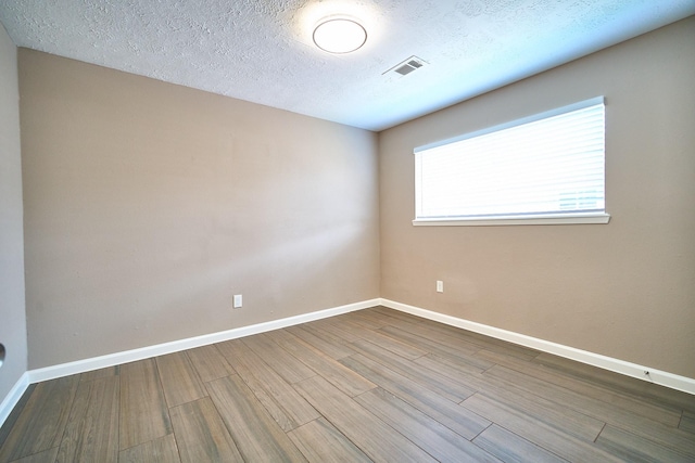 11706 Mclain Blvd, Houston, TX 77071 - spare room featuring wood finished floors, baseboards, and a textured ceiling