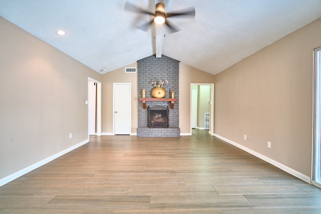 11706 Mclain Blvd, Houston, TX 77071 - unfurnished living room featuring a ceiling fan, a brick fireplace, wood finished floors, baseboards, and a textured ceiling