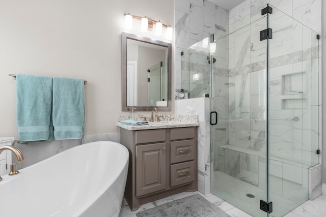28911 Ally Lynn Way, Katy, TX 77494 - bathroom featuring a freestanding tub, marble look tiles, vanity, and a marble finish shower