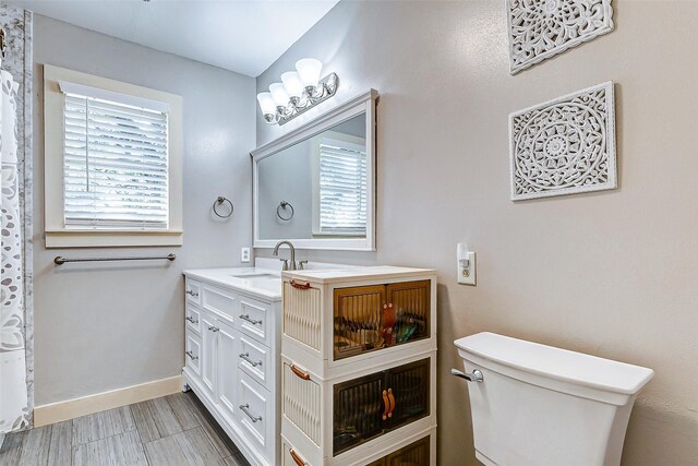 1200 E US Highway 90, Flatonia, TX 78941 - bathroom with toilet, vanity, and baseboards