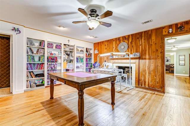 1200 E US Highway 90, Flatonia, TX 78941 - dining room with wooden walls, a ceiling fan, light wood-style flooring, and built in features