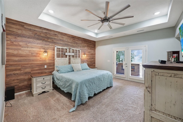 19202 Indigo Lake Dr, Magnolia, TX 77355 - carpeted bedroom featuring access to exterior, wood walls, a raised ceiling, recessed lighting, and a ceiling fan