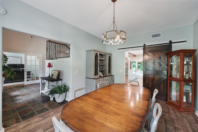 19202 Indigo Lake Dr, Magnolia, TX 77355 - dining area featuring a barn door and a chandelier