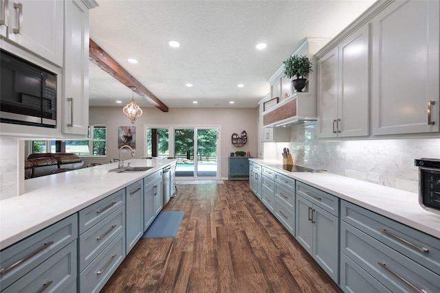 19202 Indigo Lake Dr, Magnolia, TX 77355 - kitchen with a sink, black electric cooktop, gray cabinets, recessed lighting, and beam ceiling