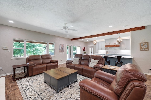 19202 Indigo Lake Dr, Magnolia, TX 77355 - living area with a textured ceiling, baseboards, light wood-style flooring, ceiling fan, and recessed lighting
