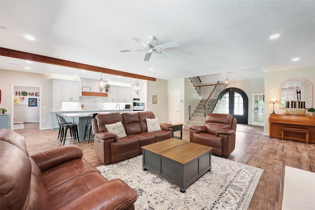 19202 Indigo Lake Dr, Magnolia, TX 77355 - living area with stairs, ceiling fan, recessed lighting, light wood finished floors, and a textured ceiling