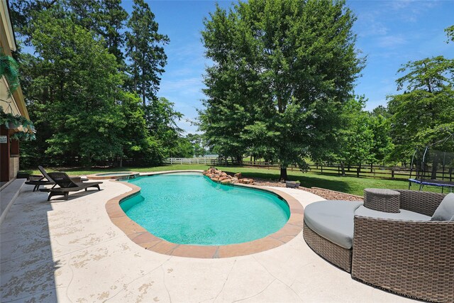 19202 Indigo Lake Dr, Magnolia, TX 77355 - view of swimming pool with a trampoline, a patio area, and a pool with connected hot tub