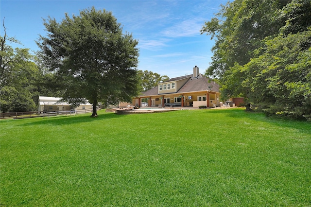19202 Indigo Lake Dr, Magnolia, TX 77355 - rear view of house with a chimney and a patio