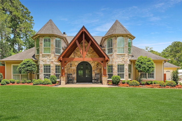 19202 Indigo Lake Dr, Magnolia, TX 77355 - view of front of property featuring french doors, stone siding, and a front lawn