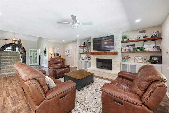 19202 Indigo Lake Dr, Magnolia, TX 77355 - living area with a ceiling fan, stairway, wood finished floors, a fireplace, and recessed lighting