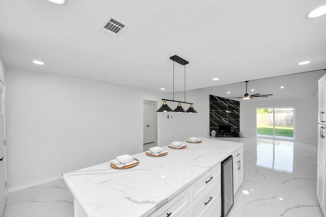 22718 Carter Moir Ln, Katy, TX 77449 - kitchen with light marble finish floors, wine cooler, recessed lighting, a ceiling fan, and white cabinets