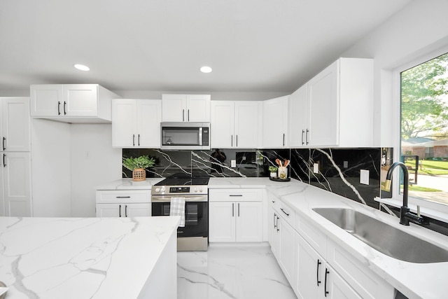22718 Carter Moir Ln, Katy, TX 77449 - kitchen featuring stainless steel appliances, a sink, recessed lighting, decorative backsplash, and white cabinets