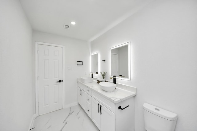 22718 Carter Moir Ln, Katy, TX 77449 - bathroom featuring marble look tile flooring, double vanity, toilet, and baseboards