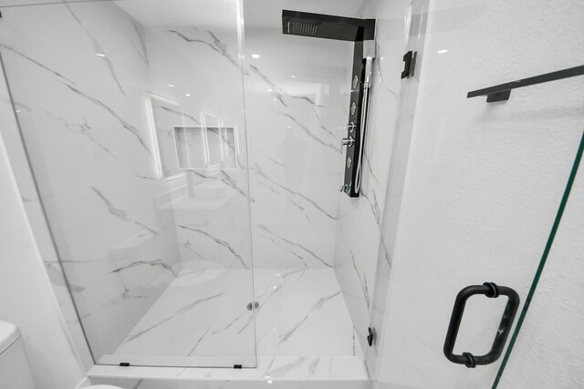 22718 Carter Moir Ln, Katy, TX 77449 - bathroom featuring toilet and a marble finish shower