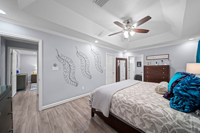 3010 Helberg Rd, Houston, TX 77092 - bedroom featuring a tray ceiling, crown molding, recessed lighting, light wood-style floors, and baseboards