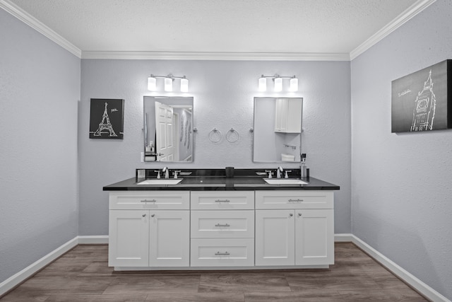 3010 Helberg Rd, Houston, TX 77092 - full bath featuring ornamental molding, double vanity, wood finished floors, baseboards, and a textured ceiling