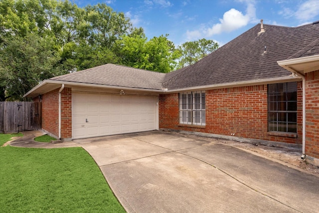 14507 Sycamore Lake Rd, Houston, TX 77062 - view of home's exterior featuring driveway, an attached garage, brick siding, and roof with shingles