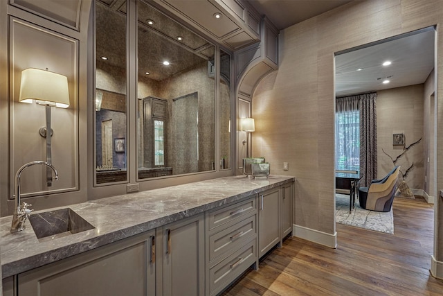3637 Meadow Lake Ln, Houston, TX 77027 - bar area featuring a sink, dark wood-style floors, baseboards, and arched walkways