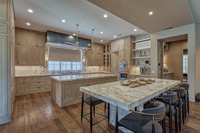 3637 Meadow Lake Ln, Houston, TX 77027 - kitchen featuring a center island with sink, double oven, dark wood finished floors, recessed lighting, and tasteful backsplash