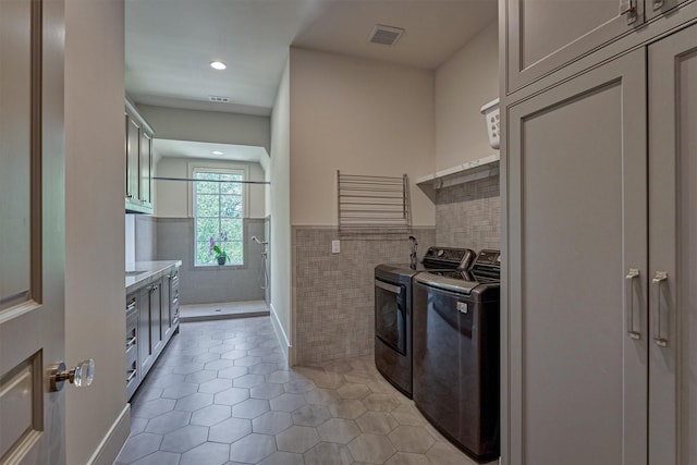 3637 Meadow Lake Ln, Houston, TX 77027 - kitchen featuring washer and dryer, tile walls, light tile patterned floors, recessed lighting, and light countertops