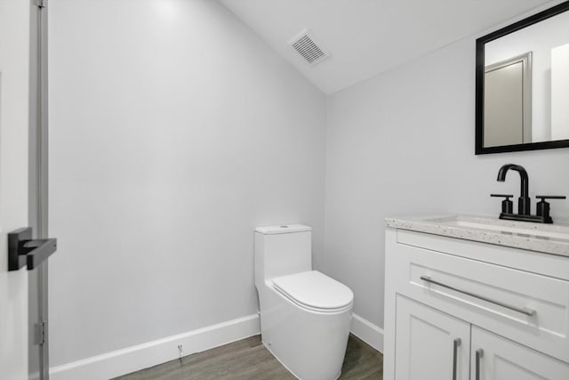 12564 Memorial Dr, Houston, TX 77024 - half bath with vanity, wood finished floors, and vaulted ceiling