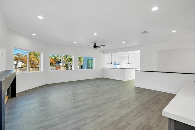 12564 Memorial Dr, Houston, TX 77024 - unfurnished living room featuring healthy amount of natural light, recessed lighting, a ceiling fan, and wood finished floors