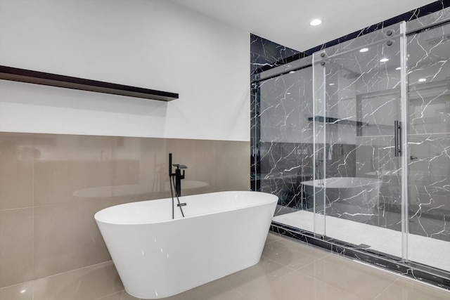 12564 Memorial Dr, Houston, TX 77024 - bathroom with tile walls, a freestanding tub, a marble finish shower, and recessed lighting
