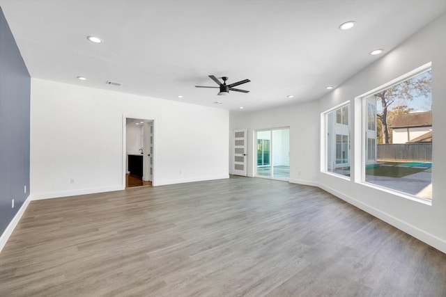 12564 Memorial Dr, Houston, TX 77024 - unfurnished living room featuring recessed lighting, a ceiling fan, and wood finished floors