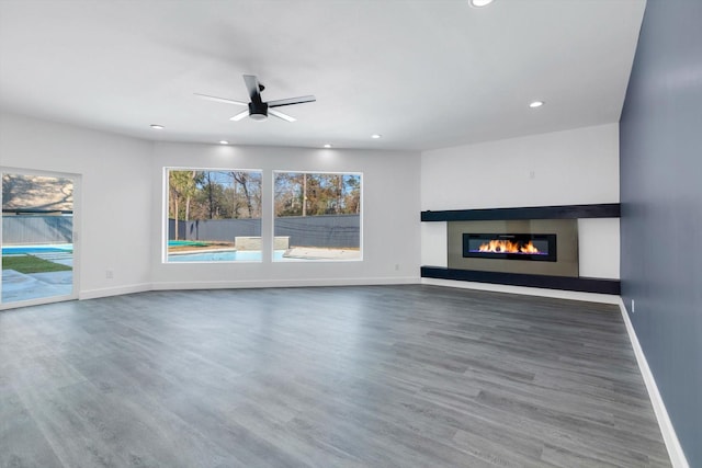12564 Memorial Dr, Houston, TX 77024 - unfurnished living room with a glass covered fireplace, recessed lighting, wood finished floors, and a ceiling fan