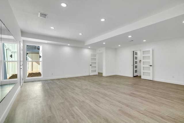 12564 Memorial Dr, Houston, TX 77024 - unfurnished living room featuring light wood-type flooring and recessed lighting