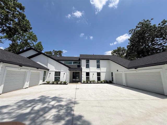 12564 Memorial Dr, Houston, TX 77024 - modern farmhouse featuring driveway, a garage, and stucco siding